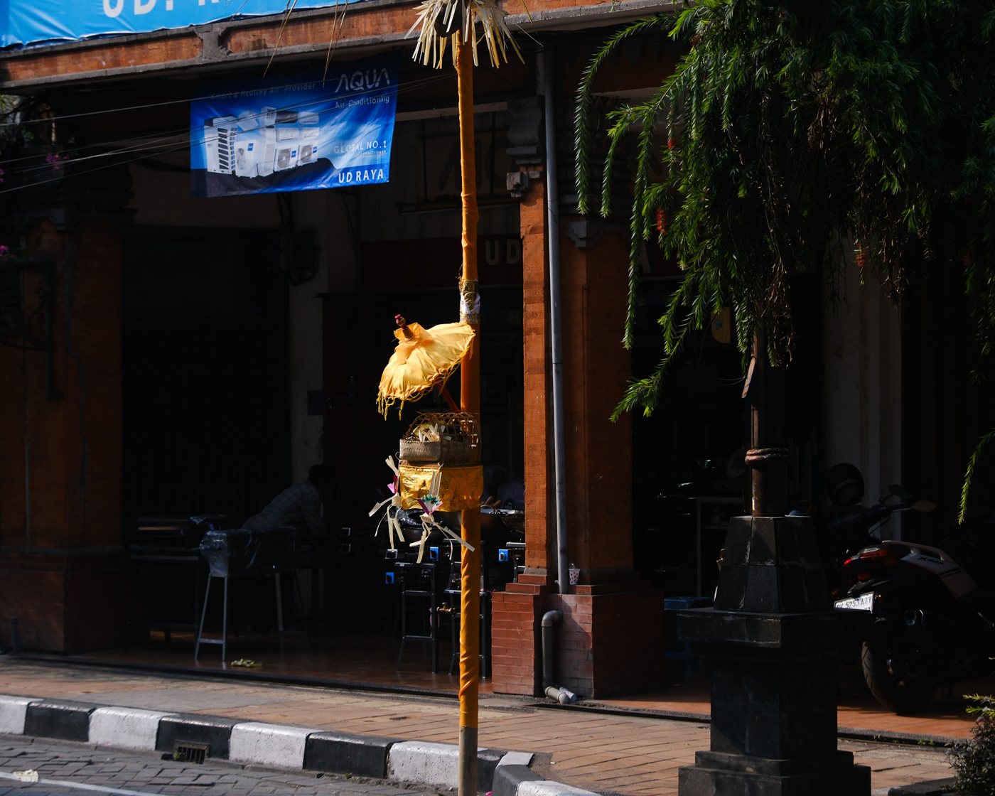 A Balinese street front with a hanging offering