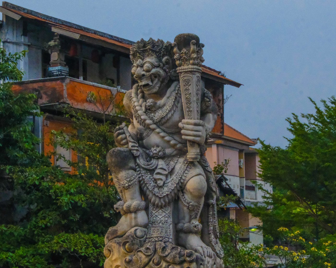 A stone guardian statue in front of a building