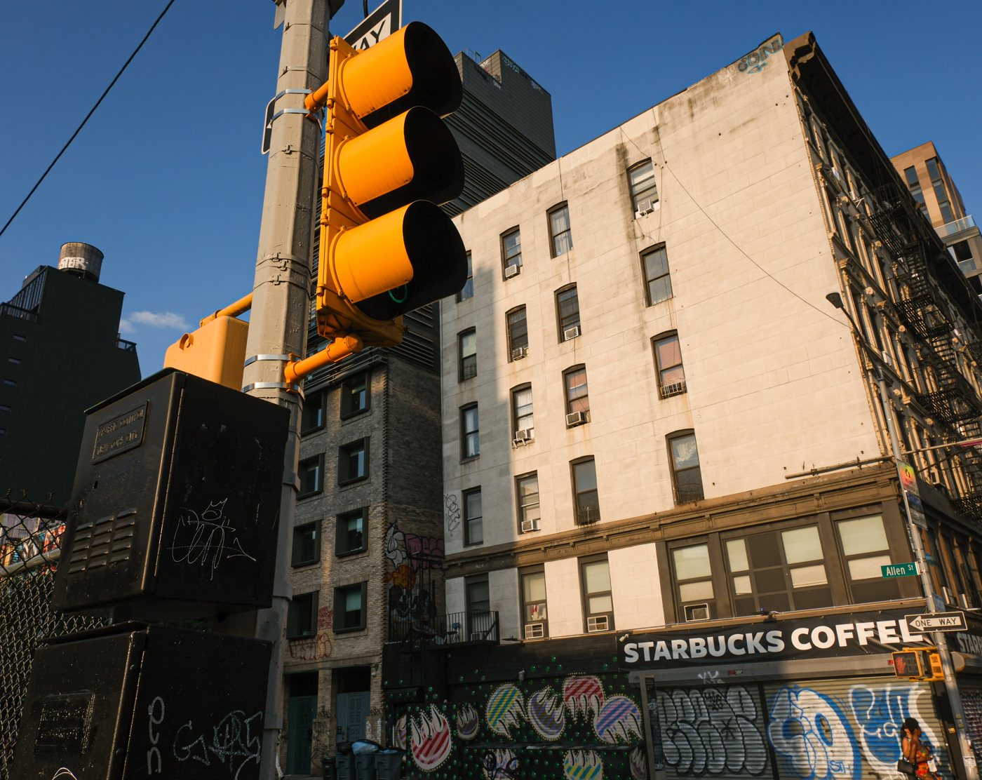 A traffic light in front of old New York buildings