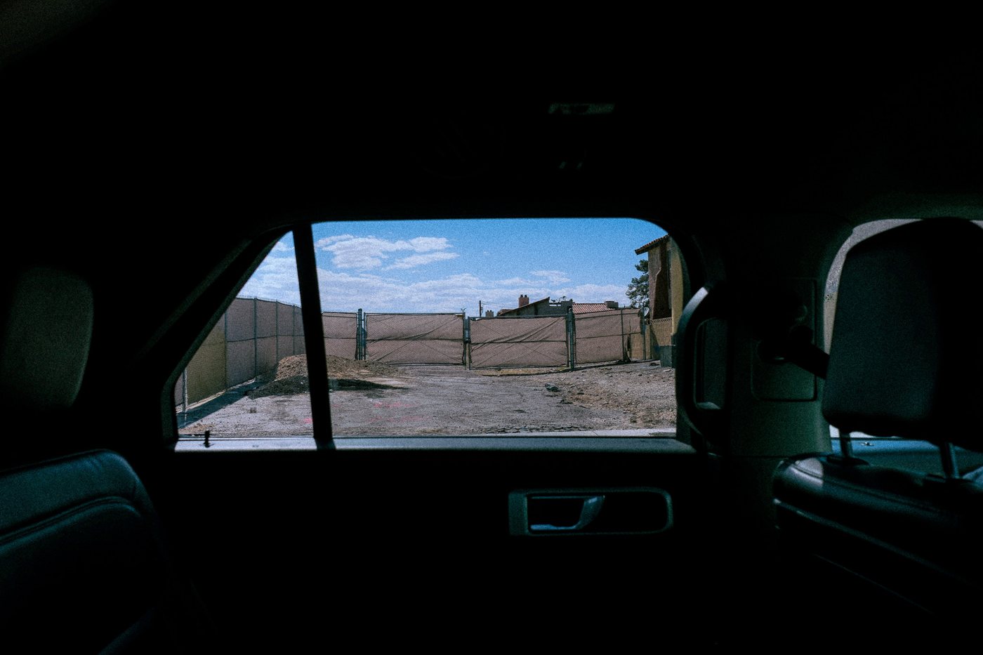 A desert lot seen through a car window